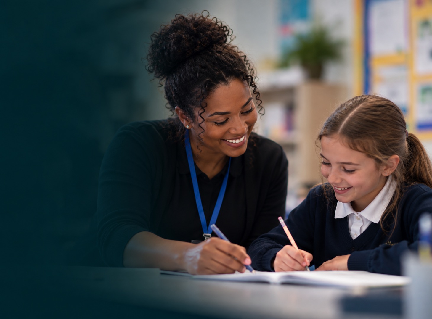 An education professional helping a pupil with schoolwork